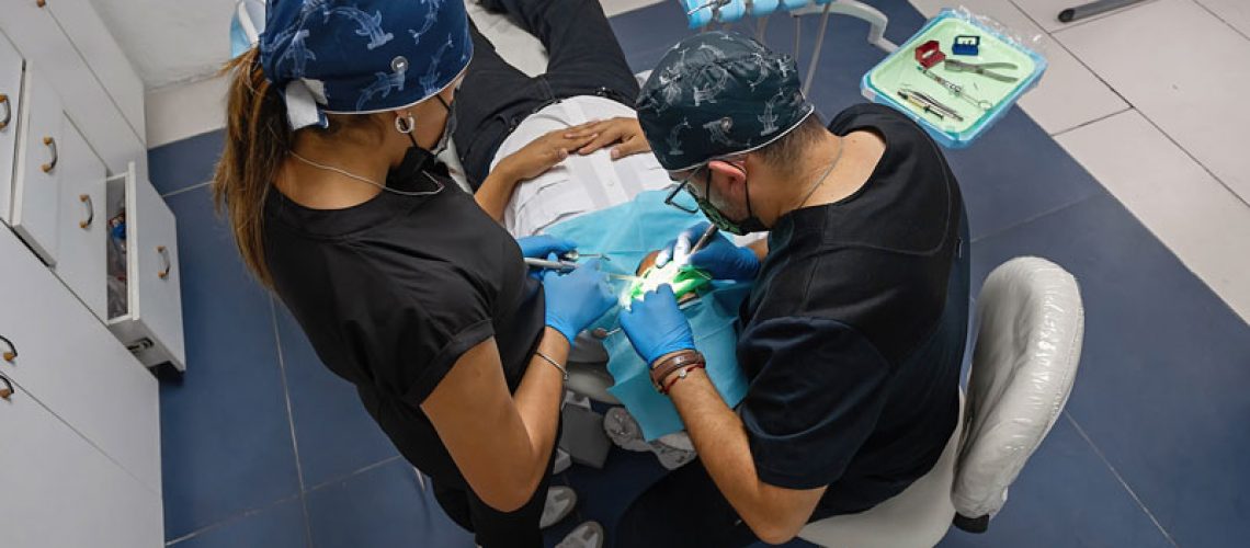 the dentist brushes teeth of patient. regular care and prevention of dental diseases. modern professional clinic