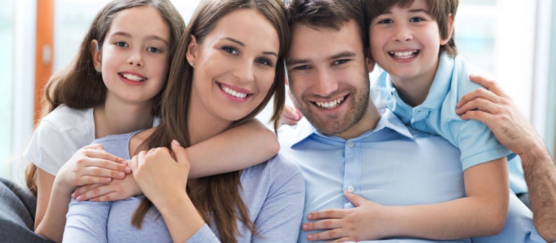 image of a family smiling after going to a family dentistry dentist inn Pearl, MS called Key Dental Group.